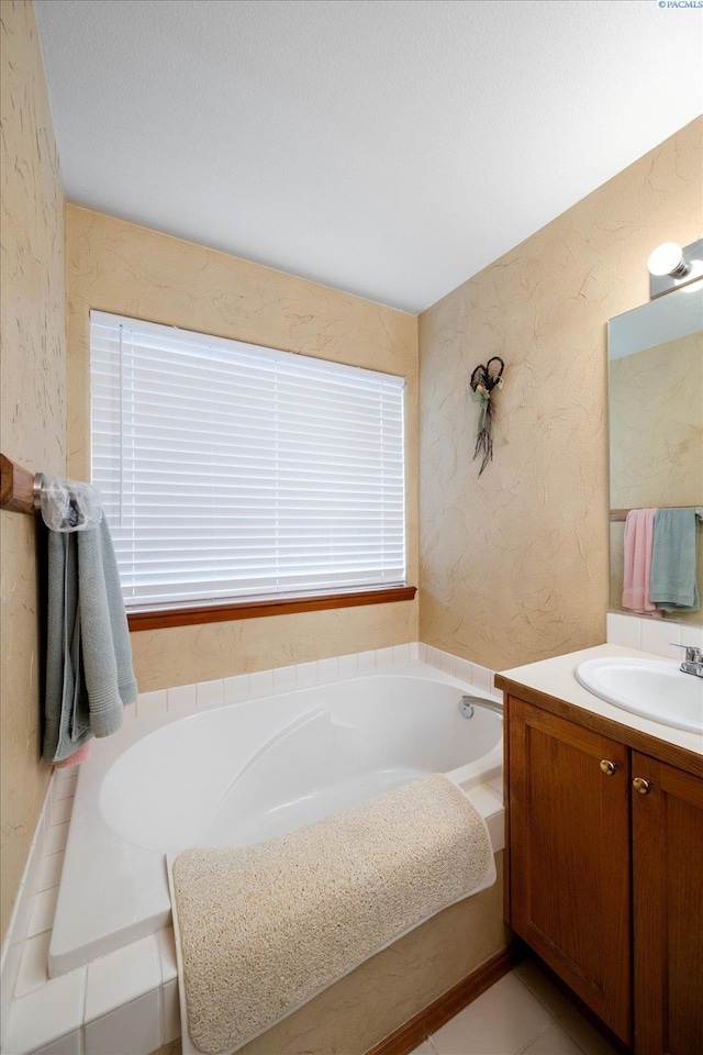 full bath with a garden tub, a textured wall, wallpapered walls, and vanity