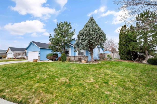 view of front of property with concrete driveway, an attached garage, fence, a front yard, and brick siding