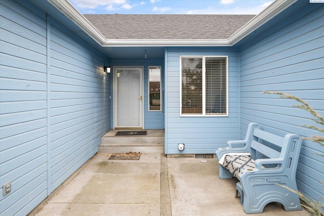 property entrance with roof with shingles