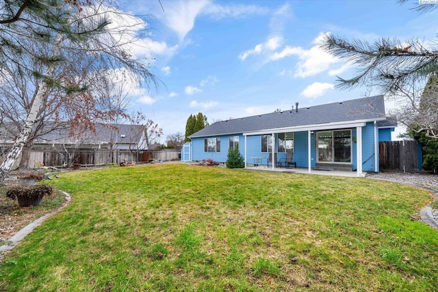 rear view of house featuring a patio area, a fenced backyard, and a lawn