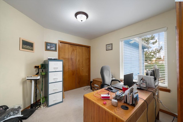 office space with light carpet and baseboards