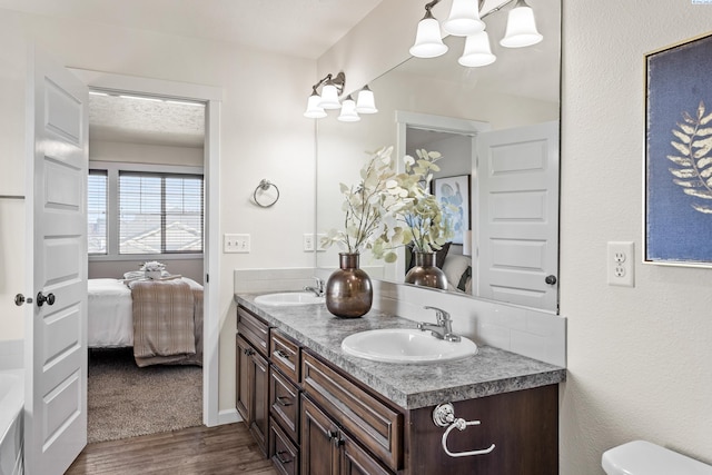 4006 Phoenix Ln, Pasco, WA 99301 - ensuite bathroom featuring double vanity, a sink, ensuite bath, and wood finished floors