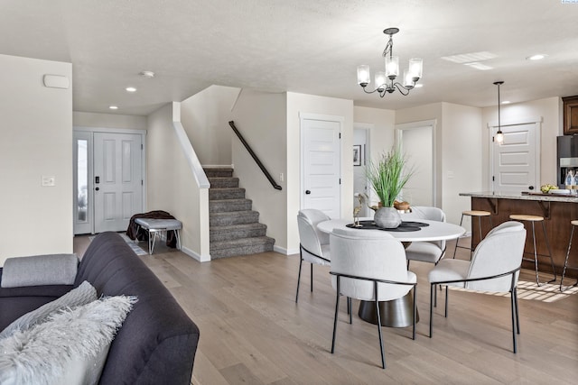 4006 Phoenix Ln, Pasco, WA 99301 - dining space with a notable chandelier, light wood-style floors, stairway, and recessed lighting