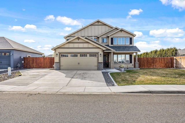 4006 Phoenix Ln, Pasco, WA 99301 - craftsman-style house with fence, stone siding, driveway, a front yard, and a garage