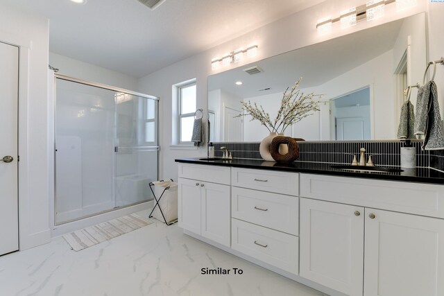 1608 Diamond Ave, Grandview, WA 98930 - bathroom with double vanity, marble look tiles, a stall shower, and tasteful backsplash