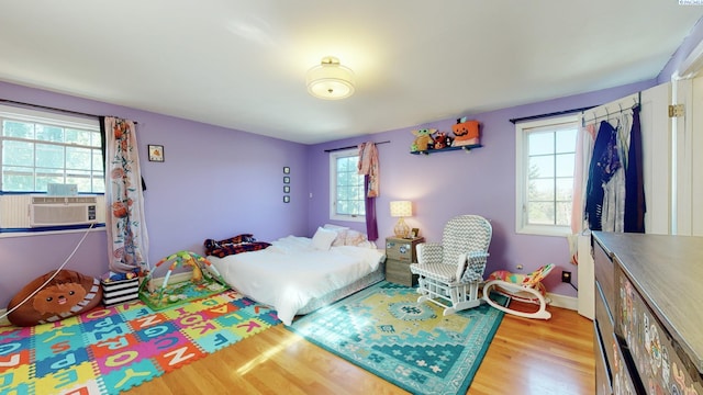 420 SE Dexter St, Pullman, WA 99163 - bedroom featuring cooling unit, multiple windows, baseboards, and wood finished floors