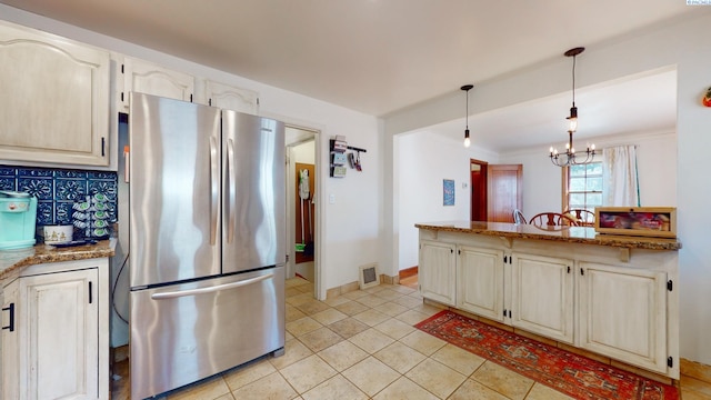 420 SE Dexter St, Pullman, WA 99163 - kitchen with freestanding refrigerator, visible vents, light tile patterned flooring, decorative light fixtures, and a notable chandelier