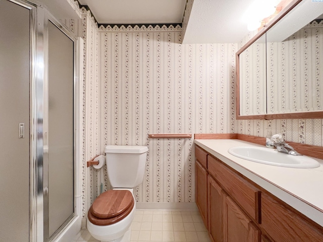 420 SE Dexter St, Pullman, WA 99163 - bathroom with vanity, wallpapered walls, tile patterned floors, toilet, and a shower stall
