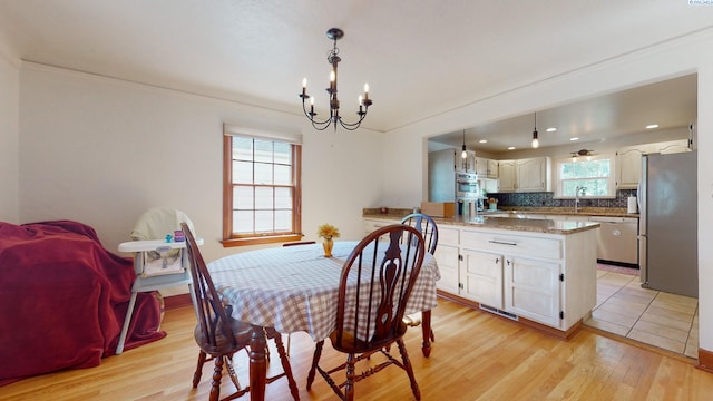 420 SE Dexter St, Pullman, WA 99163 - dining space with crown molding, visible vents, light wood-style flooring, and a notable chandelier