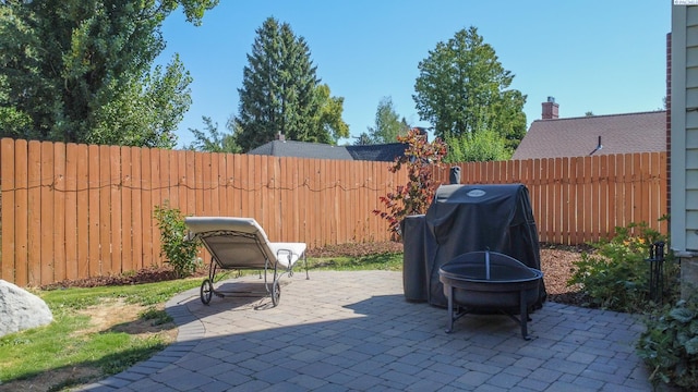420 SE Dexter St, Pullman, WA 99163 - view of patio / terrace with a fenced backyard, a grill, and a fire pit