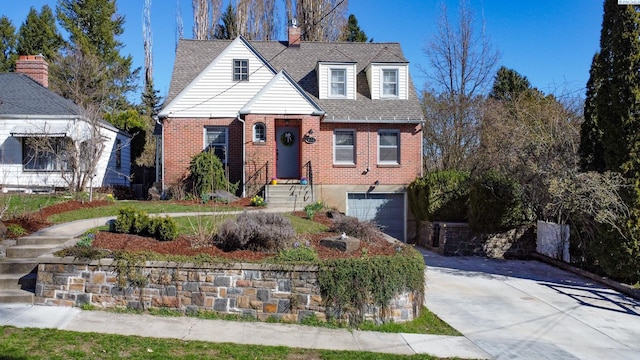 420 SE Dexter St, Pullman, WA 99163 - view of front of home with brick siding, roof with shingles, a garage, and concrete driveway