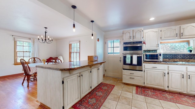 420 SE Dexter St, Pullman, WA 99163 - kitchen featuring hanging light fixtures, stainless steel double oven, an inviting chandelier, and plenty of natural light