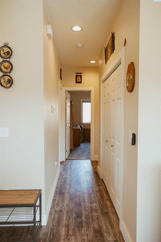 hall with dark wood-type flooring