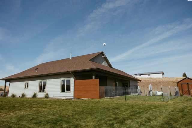 rear view of house featuring a yard