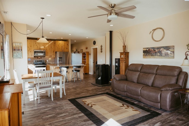 living room with ceiling fan and dark hardwood / wood-style flooring