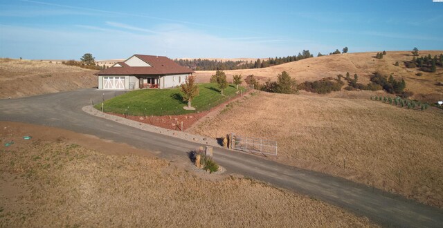 exterior space featuring a rural view and a garage