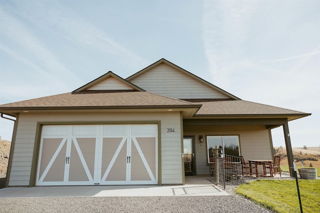 view of front facade with central AC unit and a garage