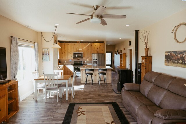 living room with dark hardwood / wood-style floors and ceiling fan