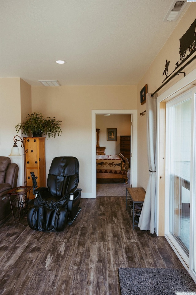 sitting room featuring dark wood-type flooring