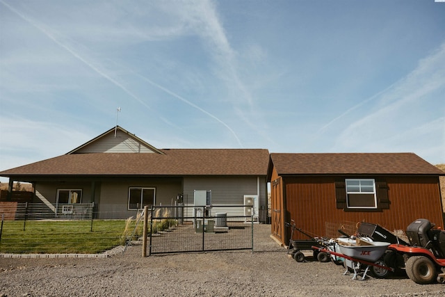 rear view of house featuring a yard