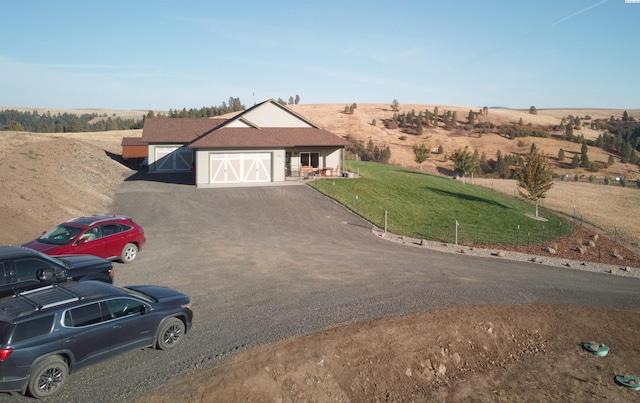 view of front of property with a rural view and a front yard