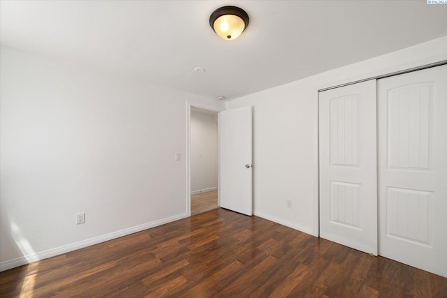 2115 W 8th Pl, Kennewick, WA 99336 - unfurnished bedroom featuring wood finished floors, baseboards, and a closet