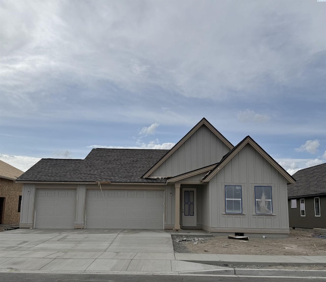 2817 Avrio Ave, Richland, WA 99354 - view of front of property with an attached garage, board and batten siding, driveway, and roof with shingles