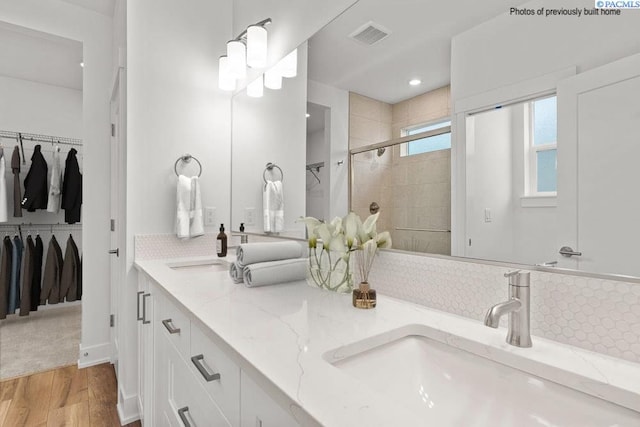 2817 Avrio Ave, Richland, WA 99354 - full bath featuring a stall shower, a walk in closet, wood finished floors, double vanity, and recessed lighting