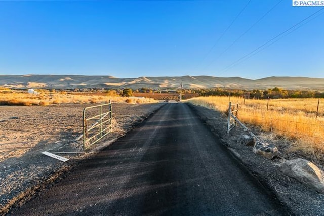 view of road with a mountain view and a rural view