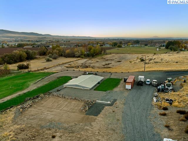 birds eye view of property with a mountain view and a rural view