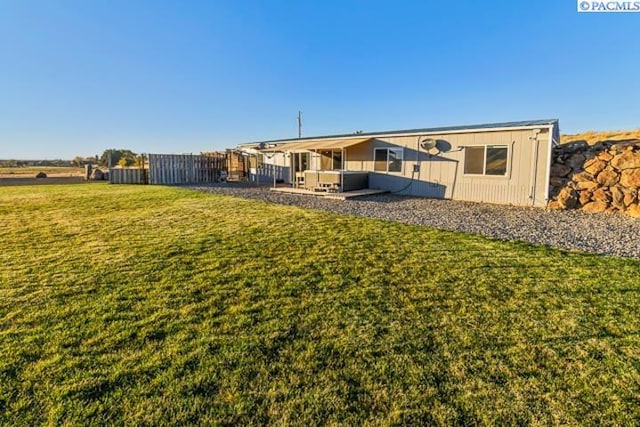 rear view of property with a lawn