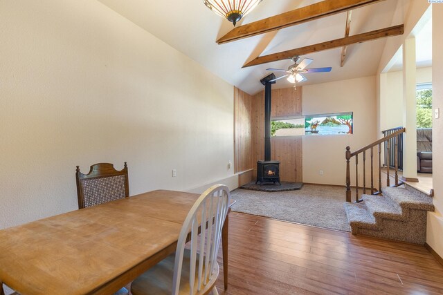 2020 Newcomer Ave, Richland, WA 99354 - dining area featuring wood finished floors, a wood stove, beam ceiling, plenty of natural light, and stairway