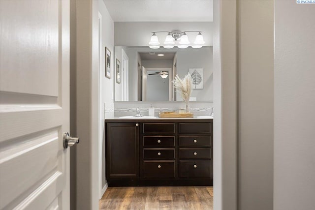 2909 S Jean St, Kennewick, WA 99336 - bathroom with double vanity, wood finished floors, and a ceiling fan