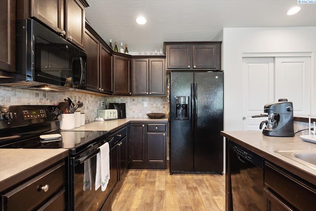 2909 S Jean St, Kennewick, WA 99336 - kitchen featuring black appliances, dark brown cabinets, light wood finished floors, decorative backsplash, and recessed lighting