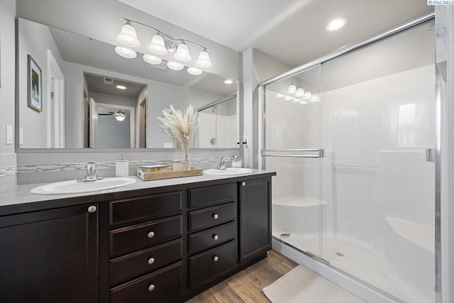 2909 S Jean St, Kennewick, WA 99336 - bathroom with double vanity, a shower stall, and wood finished floors