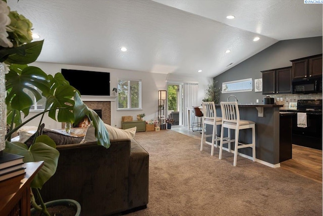 2909 S Jean St, Kennewick, WA 99336 - living room featuring a fireplace, lofted ceiling, carpet floors, and recessed lighting