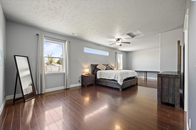 874 Pikes Peak Dr, West Richland, WA 99353 - bedroom with baseboards, multiple windows, a textured ceiling, dark wood-style floors, and a ceiling fan