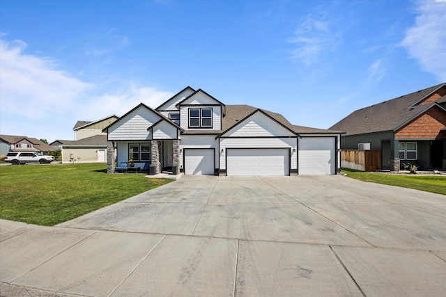 874 Pikes Peak Dr, West Richland, WA 99353 - view of front of home with driveway, an attached garage, and stone siding
