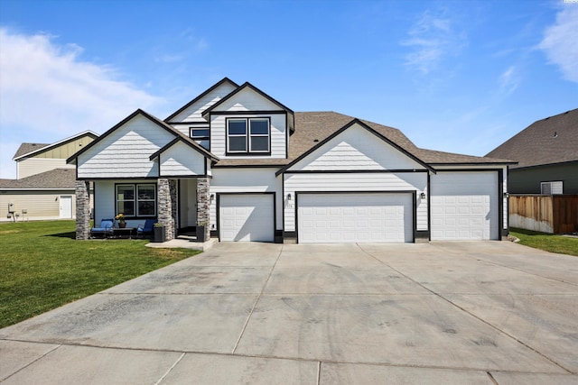 874 Pikes Peak Dr, West Richland, WA 99353 - view of front of house with driveway, stone siding, and a garage