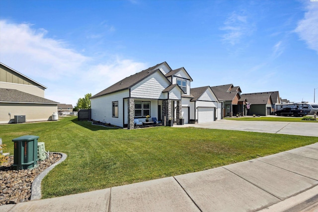 874 Pikes Peak Dr, West Richland, WA 99353 - view of front of house with concrete driveway, a front lawn, central air condition unit, a garage, and stone siding