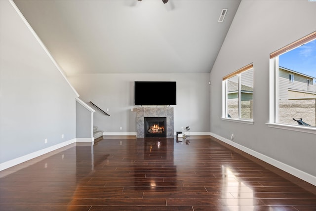 874 Pikes Peak Dr, West Richland, WA 99353 - unfurnished living room with a tiled fireplace, stairs, wood finished floors, a ceiling fan, and baseboards