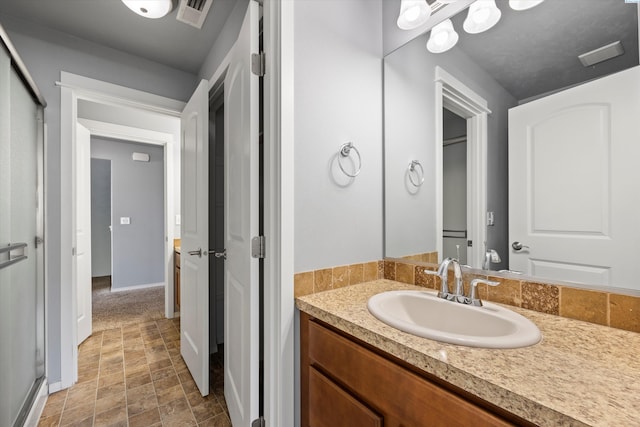 874 Pikes Peak Dr, West Richland, WA 99353 - bathroom with vanity, baseboards, and stone finish flooring
