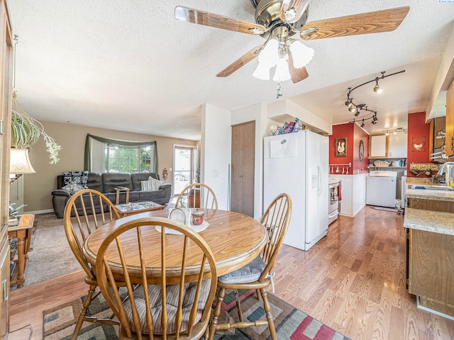902 W 44th Pl, Kennewick, WA 99337 - dining area with washer / clothes dryer, a textured ceiling, ceiling fan, light wood-style floors, and rail lighting