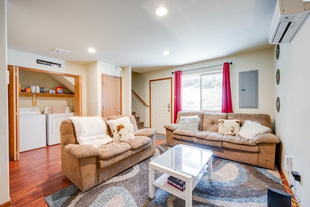 815 NE Illinois St, Pullman, WA 99163 - living area with a wall unit AC, electric panel, wood finished floors, stairs, and washer and clothes dryer