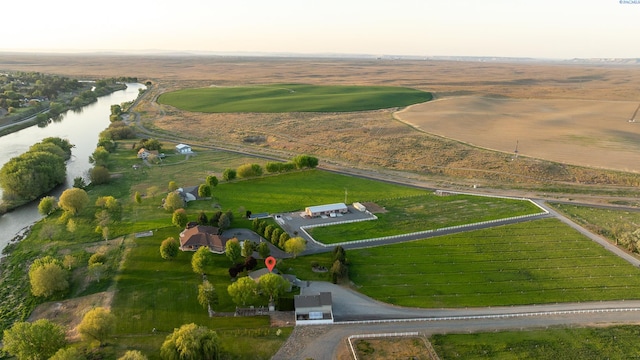 birds eye view of property with a water view and a rural view