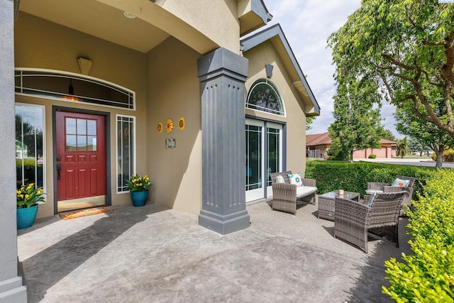 view of exterior entry featuring stucco siding