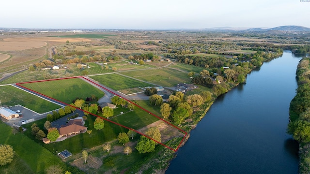 drone / aerial view with a water and mountain view