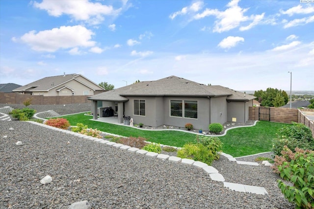325 Soaring Hawk, Richland, WA 99352 - rear view of property featuring stucco siding, a patio area, and roof with shingles