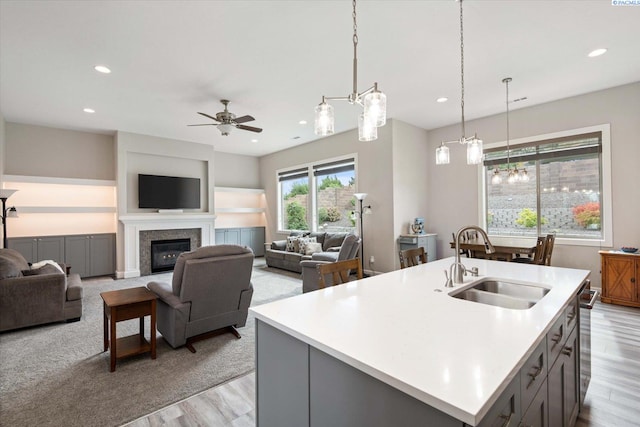 325 Soaring Hawk, Richland, WA 99352 - kitchen featuring a sink, light countertops, recessed lighting, light wood-style flooring, and hanging light fixtures