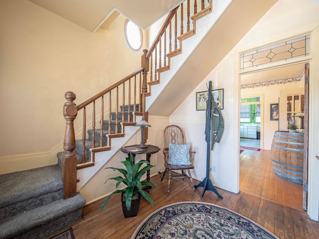 stairway with hardwood / wood-style flooring